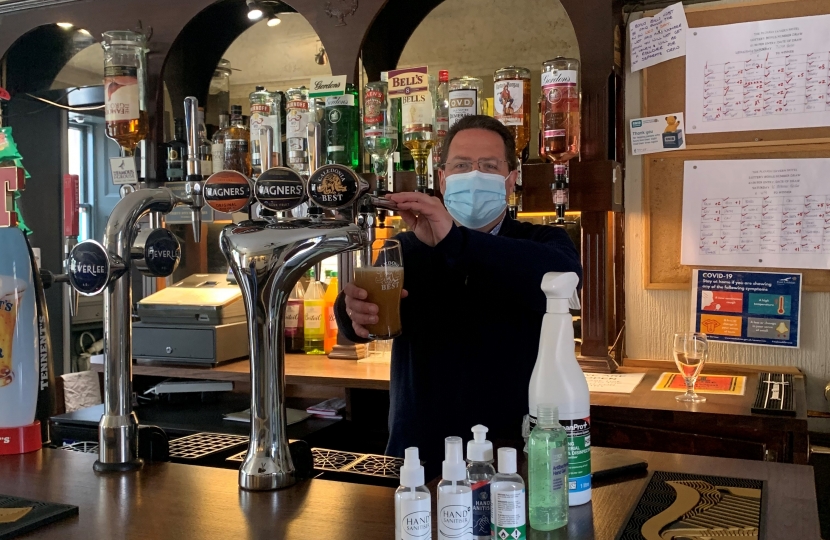 Craig Hoy MSP (left) pulling pints at the Castle Inn, Dirleton, with North Berwick Coastal Councillor Jeremy Findlay (right).