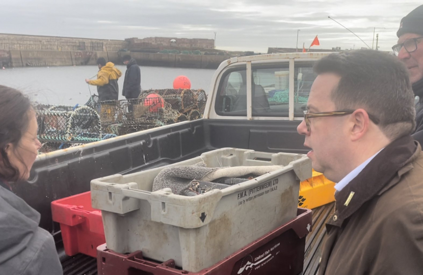 Craig Hoy MSP inspecting fishing creels at Dunbar Harbour