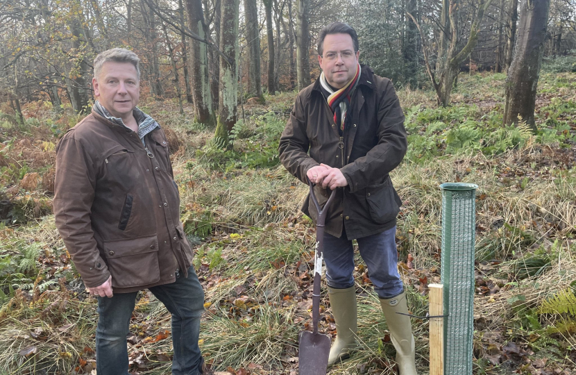 Craig Hoy MSP (right) plants a tree for the Queens Green Canopy with Neville Kilkenny (left)