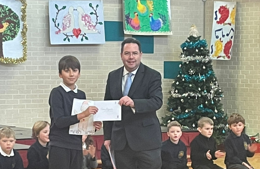 Craig Hoy MSP presenting Oskar Stefaniak, Primary 7 from St Mary's RC primary in Haddington, with his runner-up prize