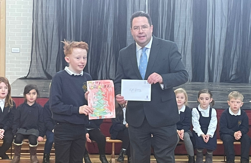 Craig Hoy MSP with Kyle Conning, Primary 7 from St Marys RC Primary School, a runner-up in Mr Hoys Christmas Card Contest