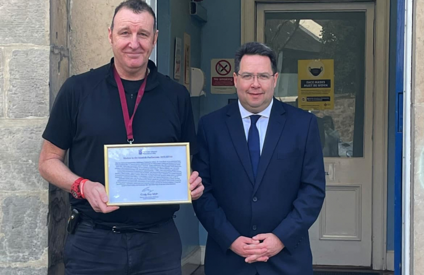 Craig Hoy MSP presenting PC Colin Boyd with framed motion