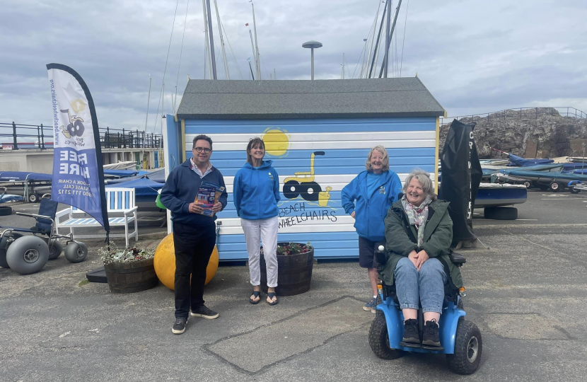 (left-to-right) Craig Hoy MSP with Bryony Capaldi, Lorna Ferry and Carol Murray; using the X8 powered chair