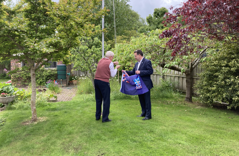 Craig Hoy MSP and Neil Rankin hoisting the Falkland Islands flag