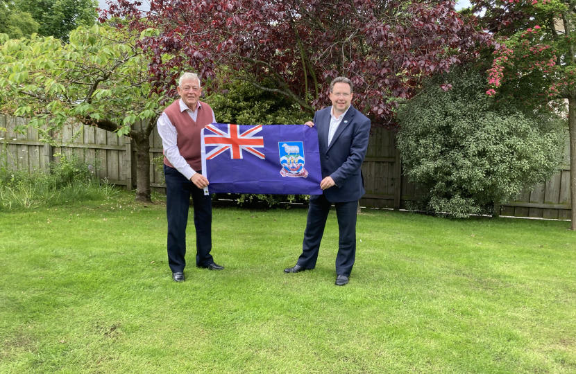 Craig Hoy MSP and Neil Rankin holding the flag of the Falklands Islands