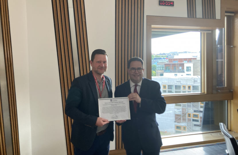 Craig Hoy MSP presenting a signed parliamentary motion to Graham Robertson