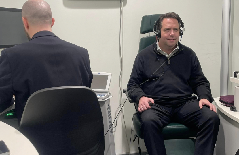 Craig Hoy MSP receiving an audiology exam at Specsavers Galashiels