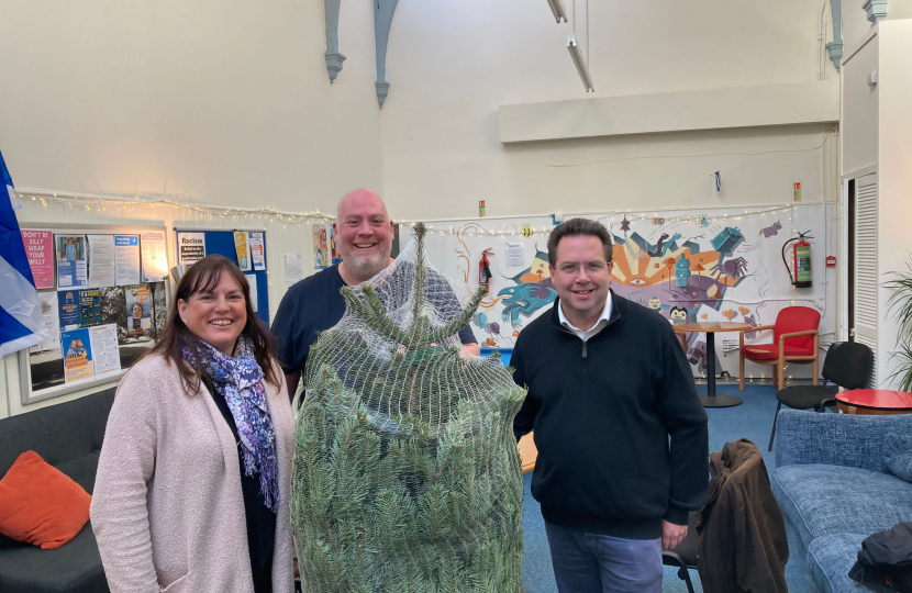 Cllr Julie Pirone, David Hobson and Craig Hoy MSP with a christmas tree donated to tweeddale youth by craig