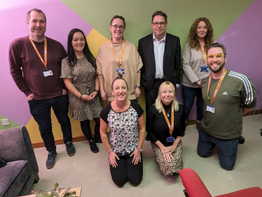 •	[Left-to-right; from back row]: Stevie Baxter (Independent Living Support Worker); Nicola Melvin (Groups Support Worker); Mhairi Kiernan (Employability Support Worker); Craig Hoy MSP; Lynne Anderson (Education and Employability Coordinator); Emma Scarcliffe (CEO); Natasha McInninie (Practice Manager); and Grant Hamilton (Personal Development Worker)