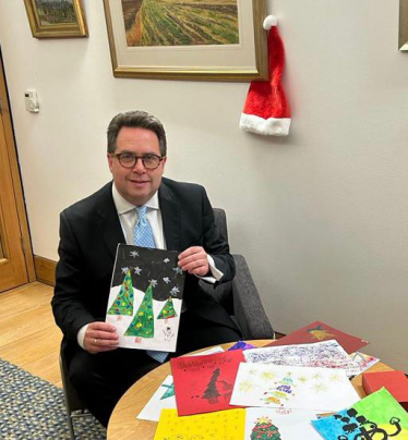 Craig Hoy with the winning xmas card