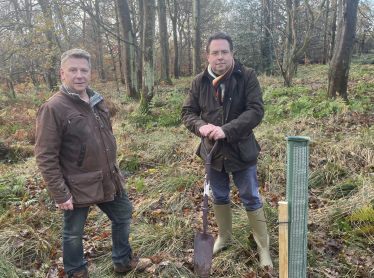 Craig Hoy MSP (right) plants a tree for the Queens Green Canopy with Neville Kilkenny (left)