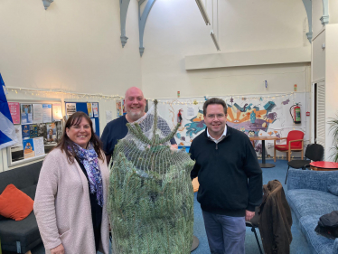 Cllr Julie Pirone, David Hobson and Craig Hoy MSP with a christmas tree donated to tweeddale youth by craig